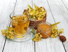 cup of herbal tea with linden flowers photo