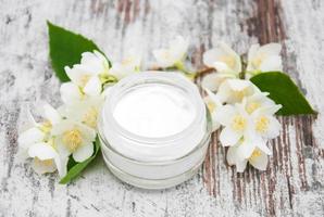 Moisturizing cream with jasmine flowers photo