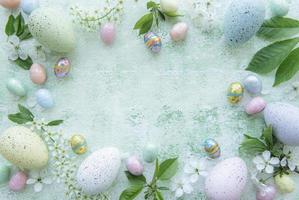 Colorful Easter eggs on green wooden background