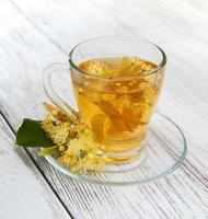 cup of herbal tea with linden flowers photo