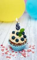 Cupcake with a numeral five candle photo