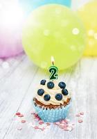 Cupcake with a numeral two candle photo