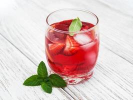 Glass of lemonade with strawberries photo