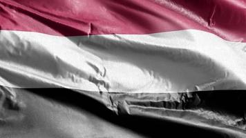 Jemen textilflagga vajar på vindslingan. yemen banner vajande på vinden. tyg textilvävnad. full fyllning bakgrund. 10 sekunders loop. video