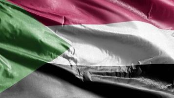 sudan textilflagga vajande på vindslingan. sudanesisk banderoll vajande på vinden. tyg textilvävnad. full fyllning bakgrund. 10 sekunders loop. video