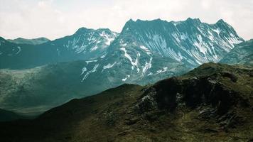 sunny landscape with views of snow-capped mountains and meadow video