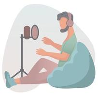 Young trendy  man with headphones sitting on lazy bag and recording podcast with microphone on tripod.  Vector flat illustration.