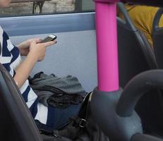 Woman texting on a bus photo
