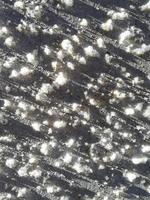 snow adhering to painted metal. texture with shadows. vertical background. winter pattern photo