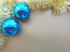 blue christmas balls and gold shiny decoration on a craft paper background. christmas greeting card. horizontal border frame with place for text, copy space photo