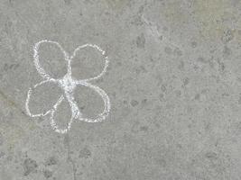 flower is drawn with chalk on the asphalt. summer. banner place for text, children, creativity, copy space photo