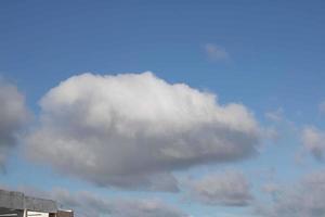 Air clouds in the blue sky photo