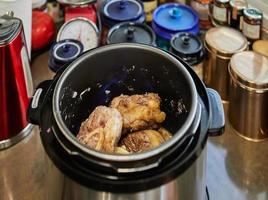 Ossobuco with spindle Beef is fried in pressure cooker. French gourmet cuisine photo