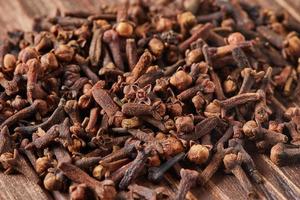 Dried spice herbs cloves for flavoring foods and natural medicines, Indian spice ingredient on wooden background photo
