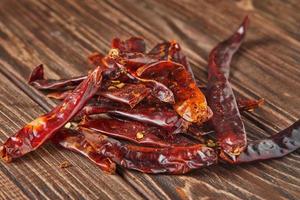 Dried red hot pepper on wooden vintage background photo