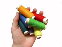 hand hold many threads of different bright colors photo
