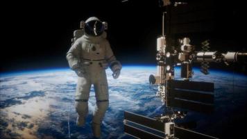 International Space Station and astronaut in outer space over the planet Earth video