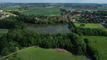 Aerial view of a playground, lake and village video