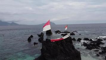 tiro aéreo da bandeira indonésia acenando em uma rocha video