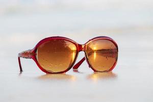 Sunglasses on sand beautiful summer beach  copy space Holiday concept. photo