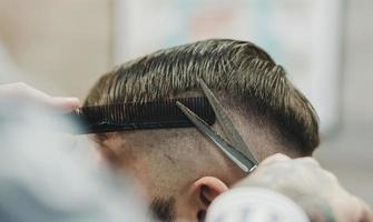 Barber with scissors and a comb photo
