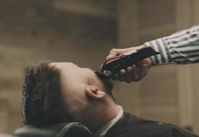Hipster guy sitting at salon photo