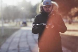 man with flying drone photo