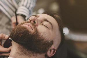 Stylish bearded man at barbershop photo