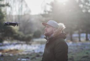 Man flying with wireless drone photo