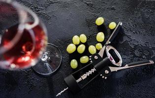 black corkscrew and grapes photo