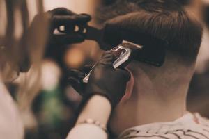 Young bearded guy at the barber shop photo