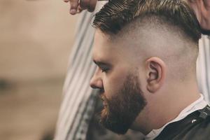 barber cuts bearded man's photo