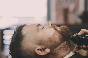 bearded man visits a barbershop photo