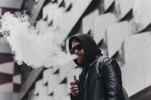 Vaping man holding a mod photo