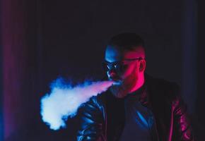 man smokes electronic cigarettes photo