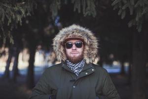 man in sunglasses and winter jacket photo