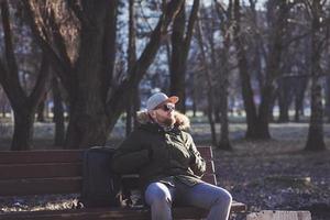 bearded man in sunglasses resting photo