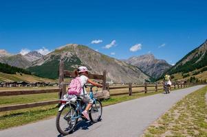 Livigno Italy 2015 Woman cycling on the bike path photo