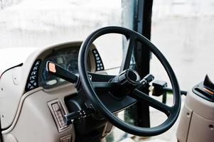Steering wheel and the controls in the cabin of the new tractor photo