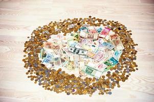 Round of coins and money on wooden background photo