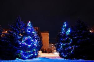 Christmas tree with garlands outdoor on frozen evening photo