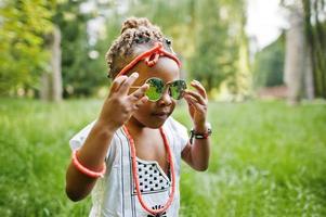 Amazing beautiful african american baby girl with sunglasses having fun photo