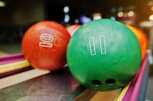 Two colored bowling balls of number 11 and 10 photo