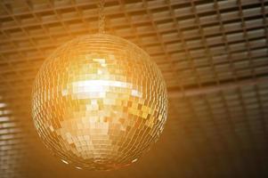 Shined disco mirror ball over the dance floor photo