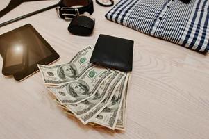 Dollars in the black leather wallet  background male accessories photo