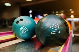 Two colored bowling balls of number 16 and 15 photo