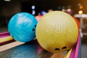 Two colored bowling balls of number 9 and 8 photo