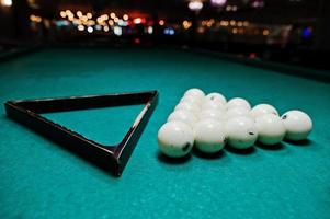 The russian billiards balls on the table with triangle photo