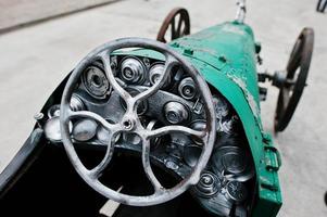 Iron handmade steering wheel at vintage sport car photo