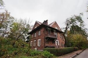 Old abandoned brick  mystic mansion. Gothic building at autumn photo